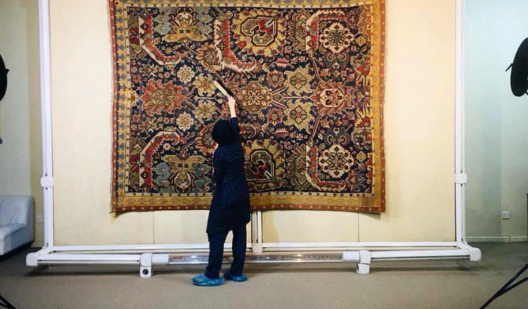 Restoring a large carpet hung on a museum frame