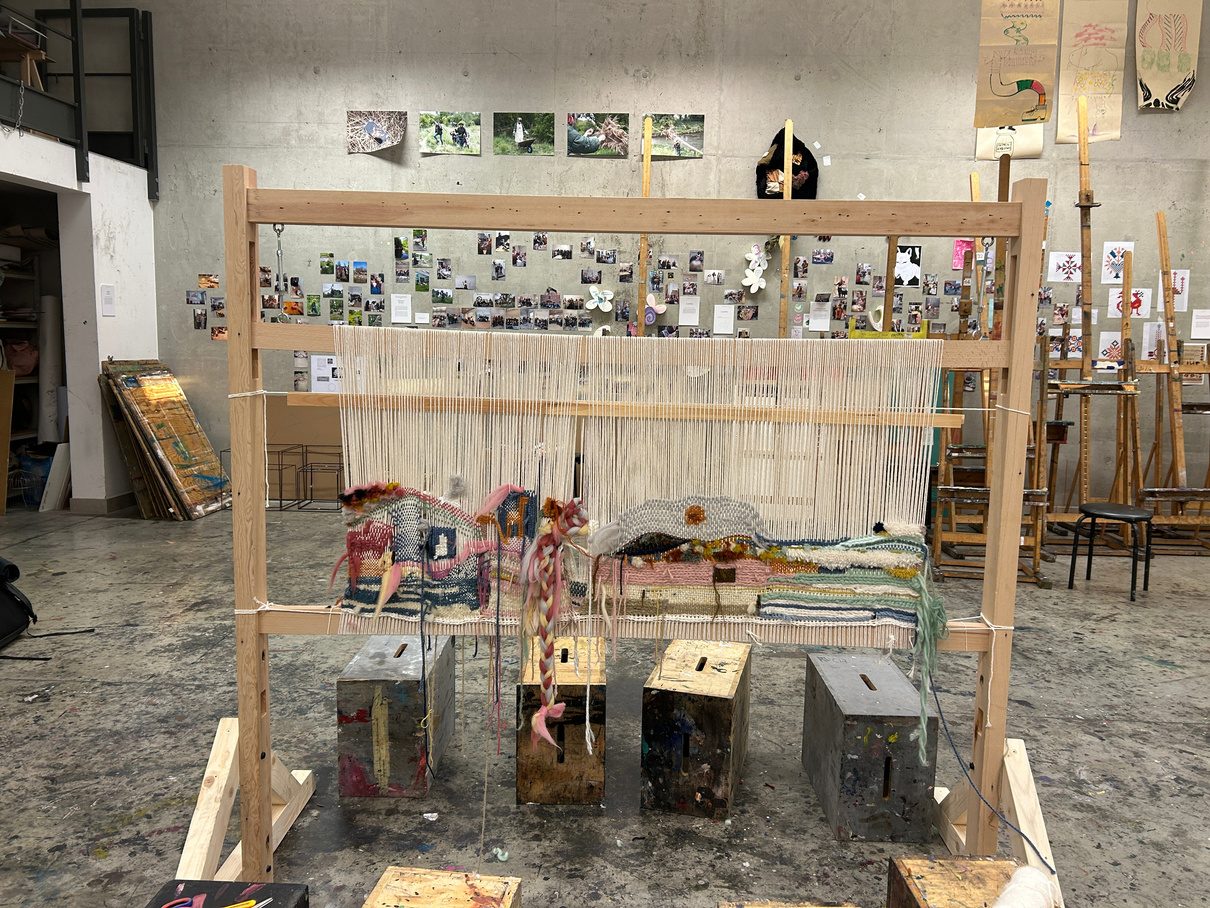 A wooden loom set up in the workshop space