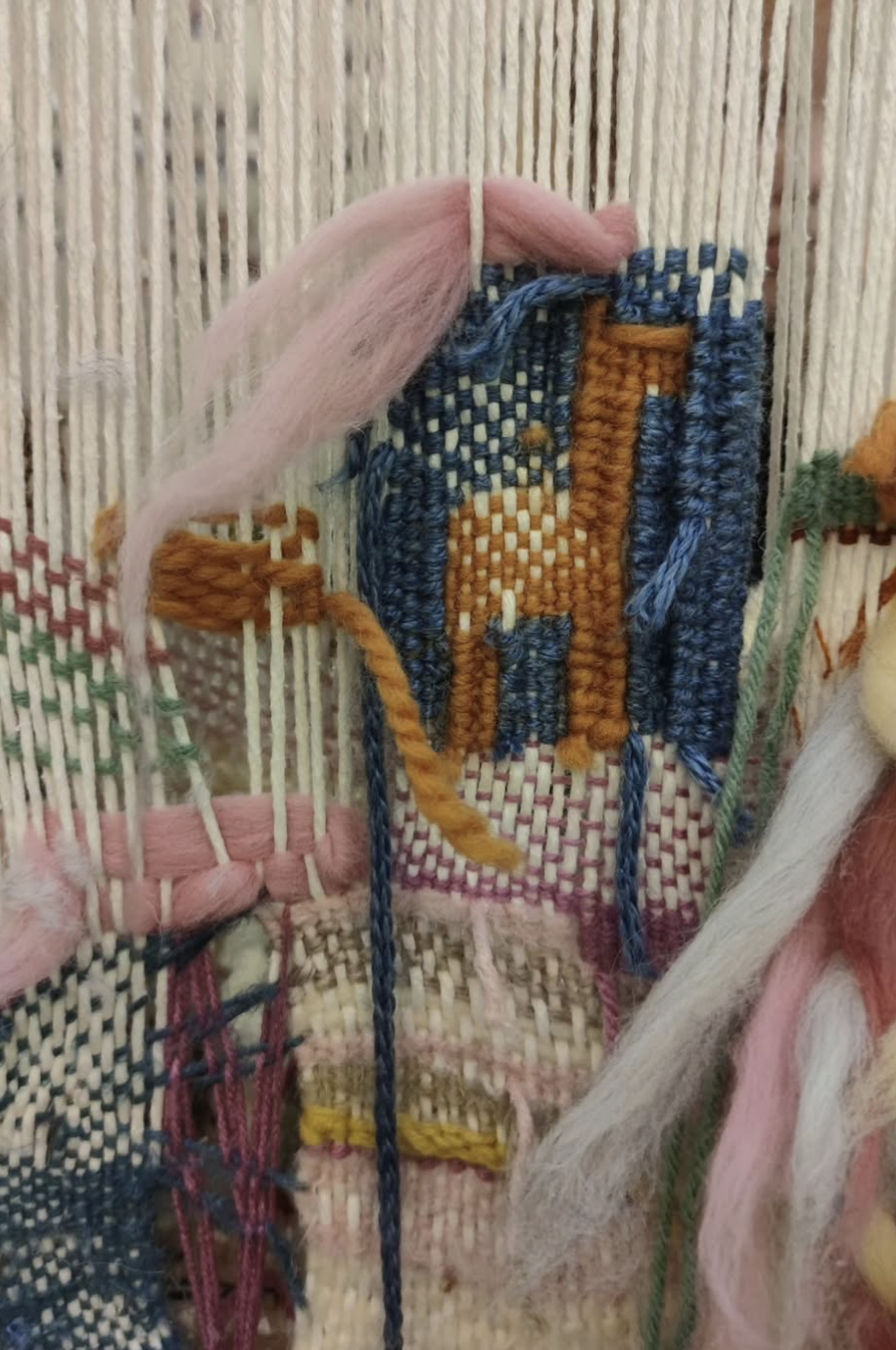 Close-up of colorful yarn woven through the warp