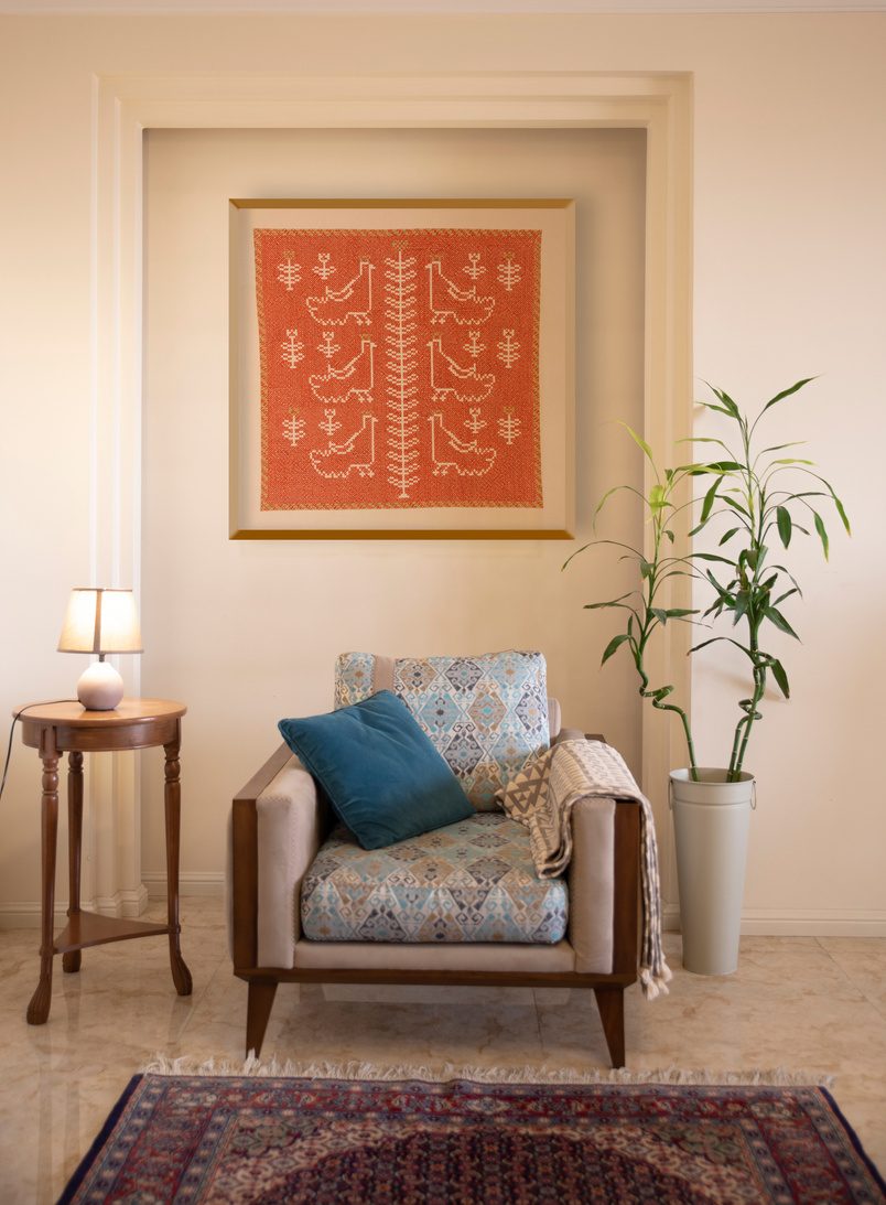 A framed motif above an armchair