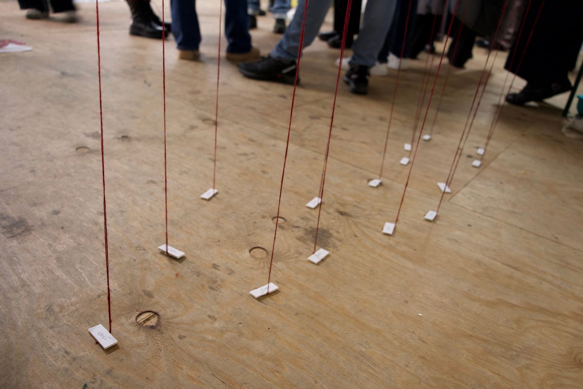Red threads anchored to the floor